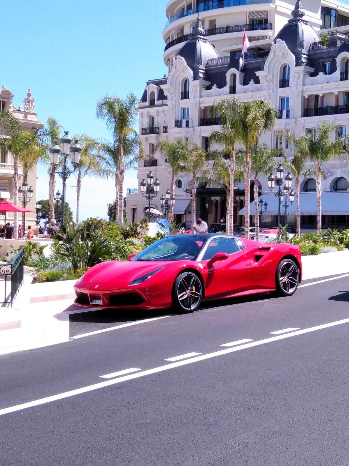 Luxury sports car in front of a Monte-Carlo palace